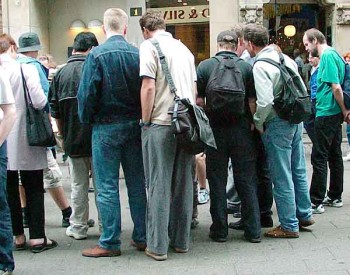 A crowd forms around a three-shell game in Copenhagen.