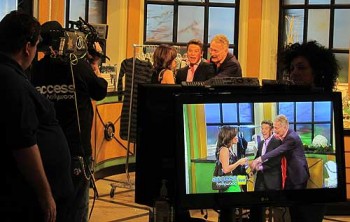 On the set of Access Hollywood with hosts Kit Hoover and Billy Bush.