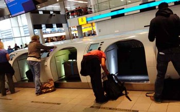 Long rows of luggage self-check stations at Amsterdam's Schiphol Airport