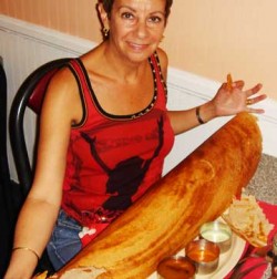 A giant version of the paper dosa, with its three little bowls of accompaniments.