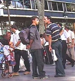 Pickpockets often work in pairs, like these two in Barcelona. The newspaper is a tool, under which they hide their moves, as in the photo above.