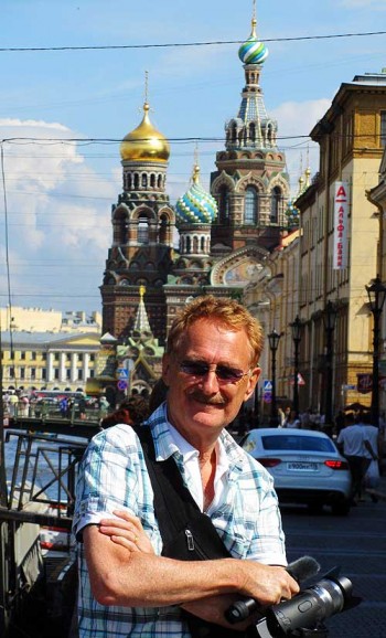 street crime in St. Petersburg, Russia. Bob Arno on the Canal Griboyedova bridge in front of the Metro station. In the background is the spectacular Church on the Spilled Blood.