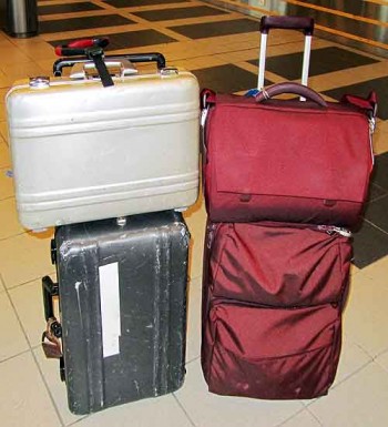 Luggage security. On the left: Bob's rig. A strip of white tape is just a spare piece, used to secure checked bags. On the right: Bambi's set-up. Not aluminum, but still like new after five years of hard use.