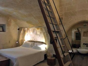 Our luxurious cave at Corte San Pietro in Matera. The ladder leads to a loft with a sitting area.