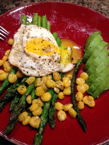 Fried egg on asparagus spears with roasted hominy (or chickpeas) and sliced avocado.