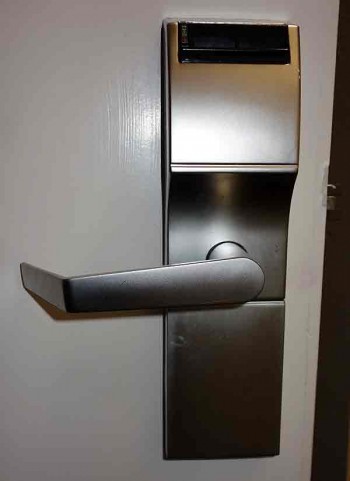 Electronic keycard lock on a hotel room door.