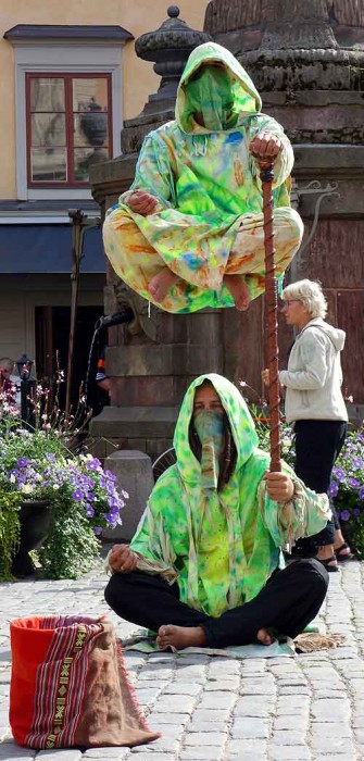 Living statue street performers levitate