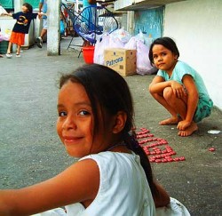 Little girls in Mexico playing with bottle caps.