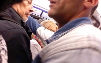 Paris pickpockets: The North African pickpocket is groping with his left hand in the pocket of the man in navy. His right arm holds the mark in place.