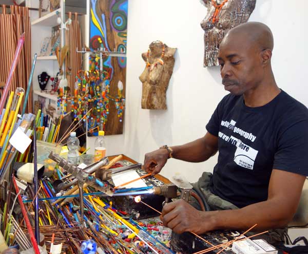 Venetian glass beads. Moulaye Niang at work in his Venice studio.