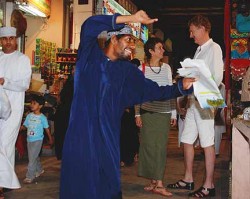 In a souk swirling with activity, we found a corner suitable for photos. This man suddenly danced in front of our camera, then danced away.