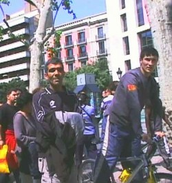 Kharem at work in Barcelona, carrying a coat with which to hide his thefts.