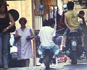 Baby thugs-in-training? Two boys on a mini-motorcycle keep up with the full-size bike they chase.