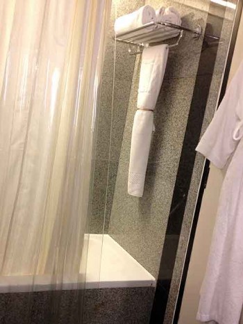 Hotel oddity: shower curtain hung backwards