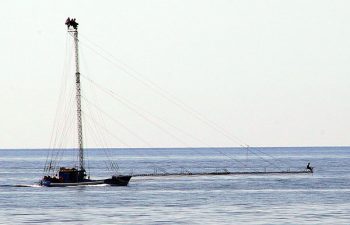 A modern swordfishers boat in Chianalea di Scilla. You can also see the driver (and two others) at the top of the mast and a harpoonist way out on the bow.