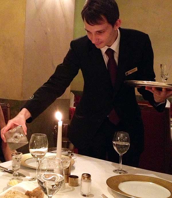 Vodka and caviar in Russia: A waiter keeps our vodka glasses full at Grand Hotel Europe