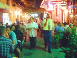 Busy waiters at outdoor restaurants.